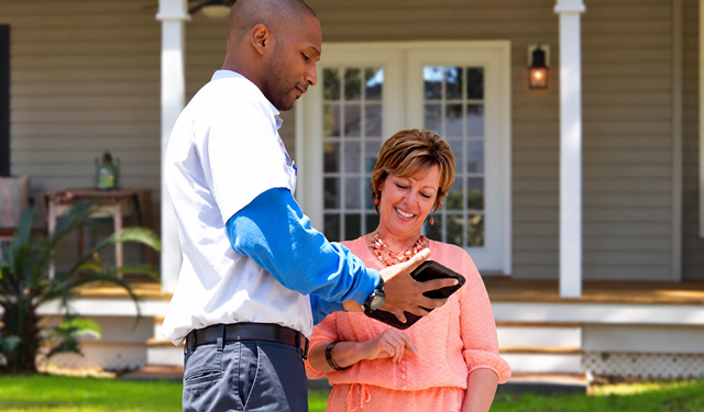 Field service worker getting a signature from a customer using the MobiWork field services software solution